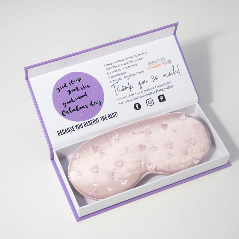 Pink 3D mulberry silk eye mask with heart patterns in a Belle Esme branded box.