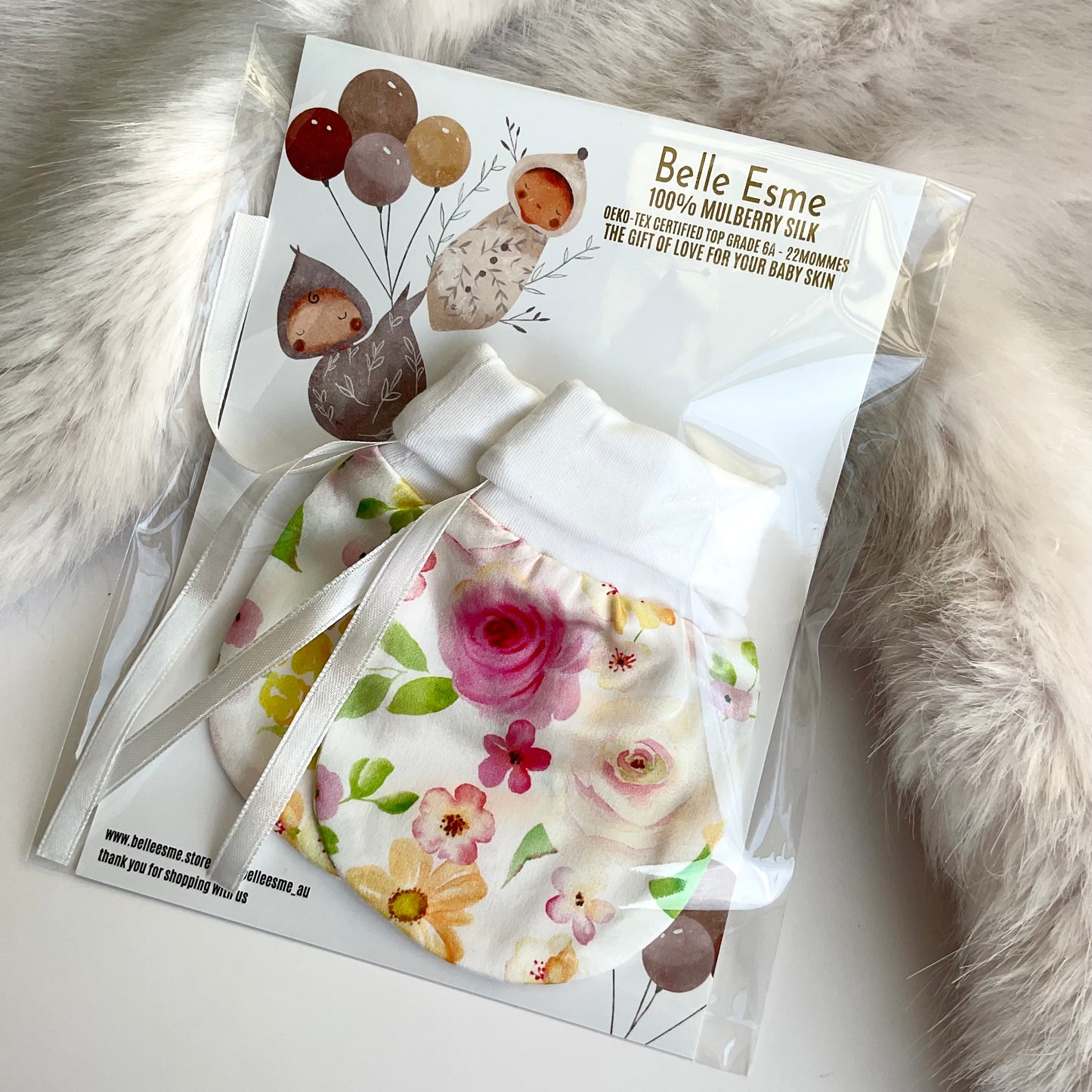 Belle Esme mulberry silk baby mittens with floral design in packaging