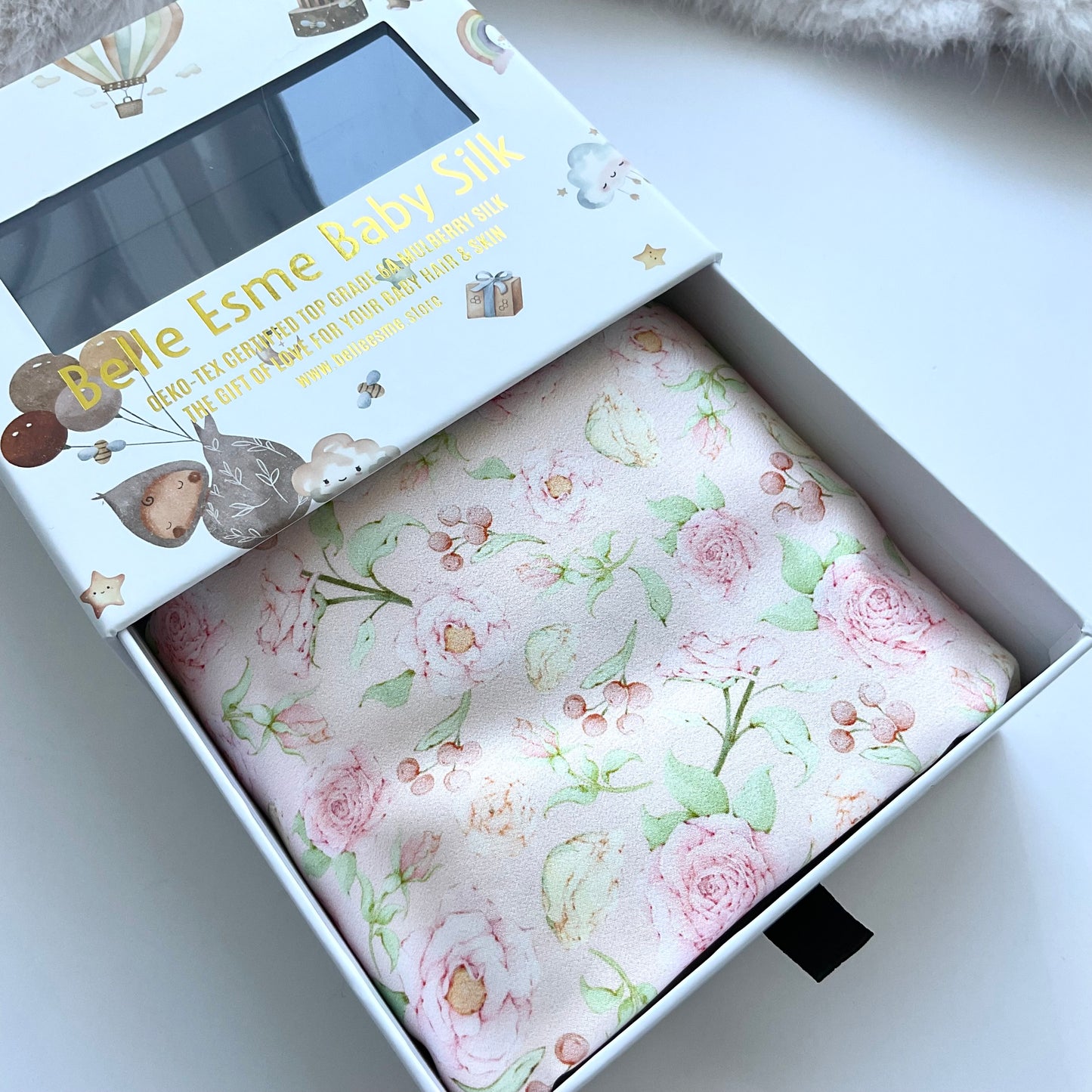 Mulberry silk baby cot slip/sleeve in cute ditsy rose pattern pastel pink colour with Belle Esme gift box close up shot