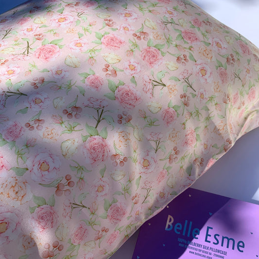 Beautiful rose-patterned mulberry silk pillow with a purple box labeled 'Belle Esme' in the background