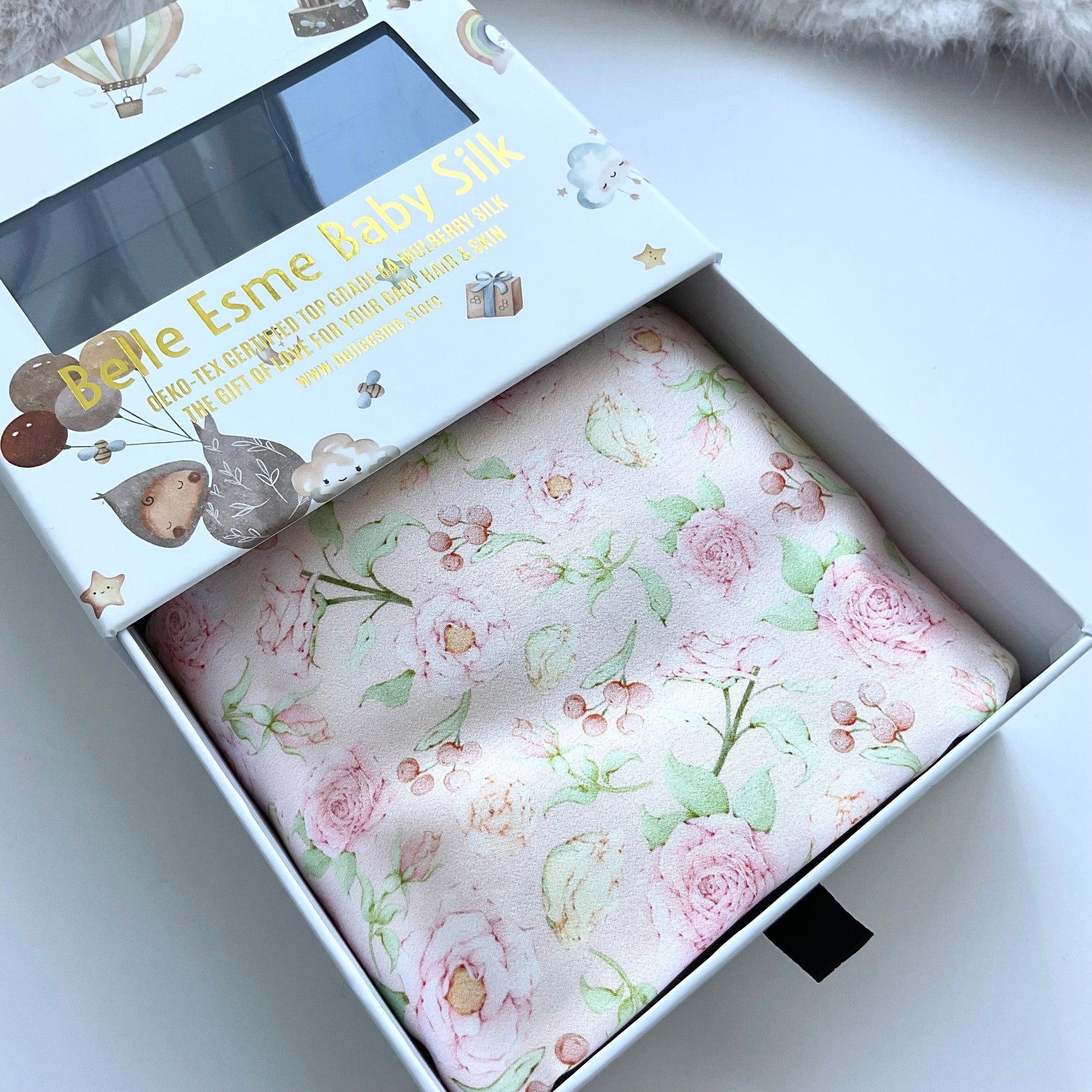 Mulberry silk baby cot slip/sleeve in cute ditsy rose pattern pastel pink colour with Belle Esme gift box close up shot